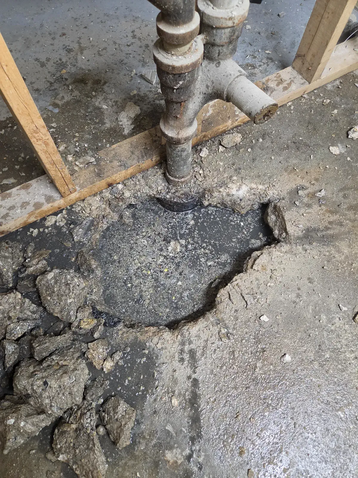 Basement floor opened up around a sewer stack