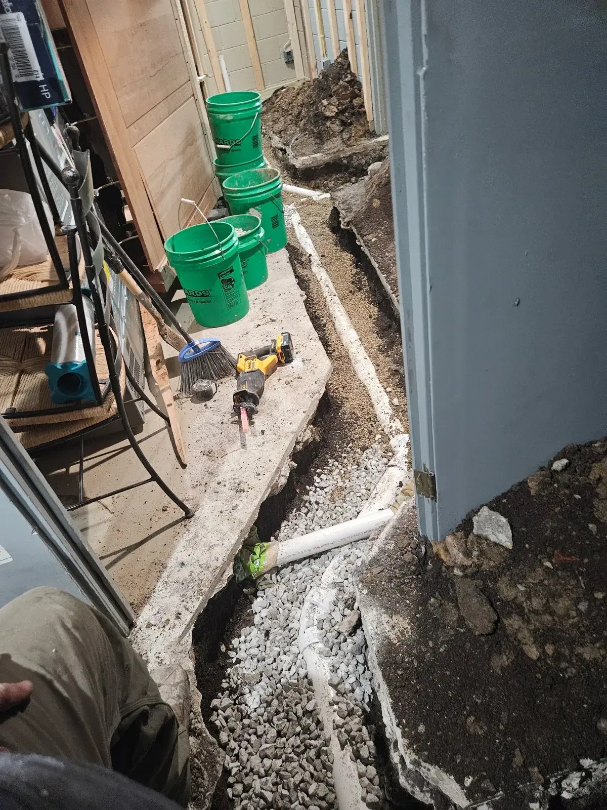 Basement floor cut open for a new sewer pipe run