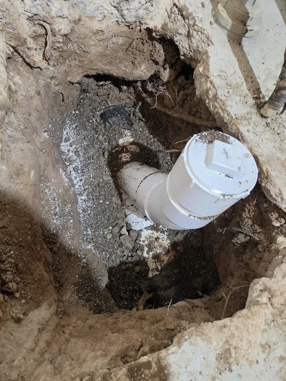 Cleanout fitting set in an open trench