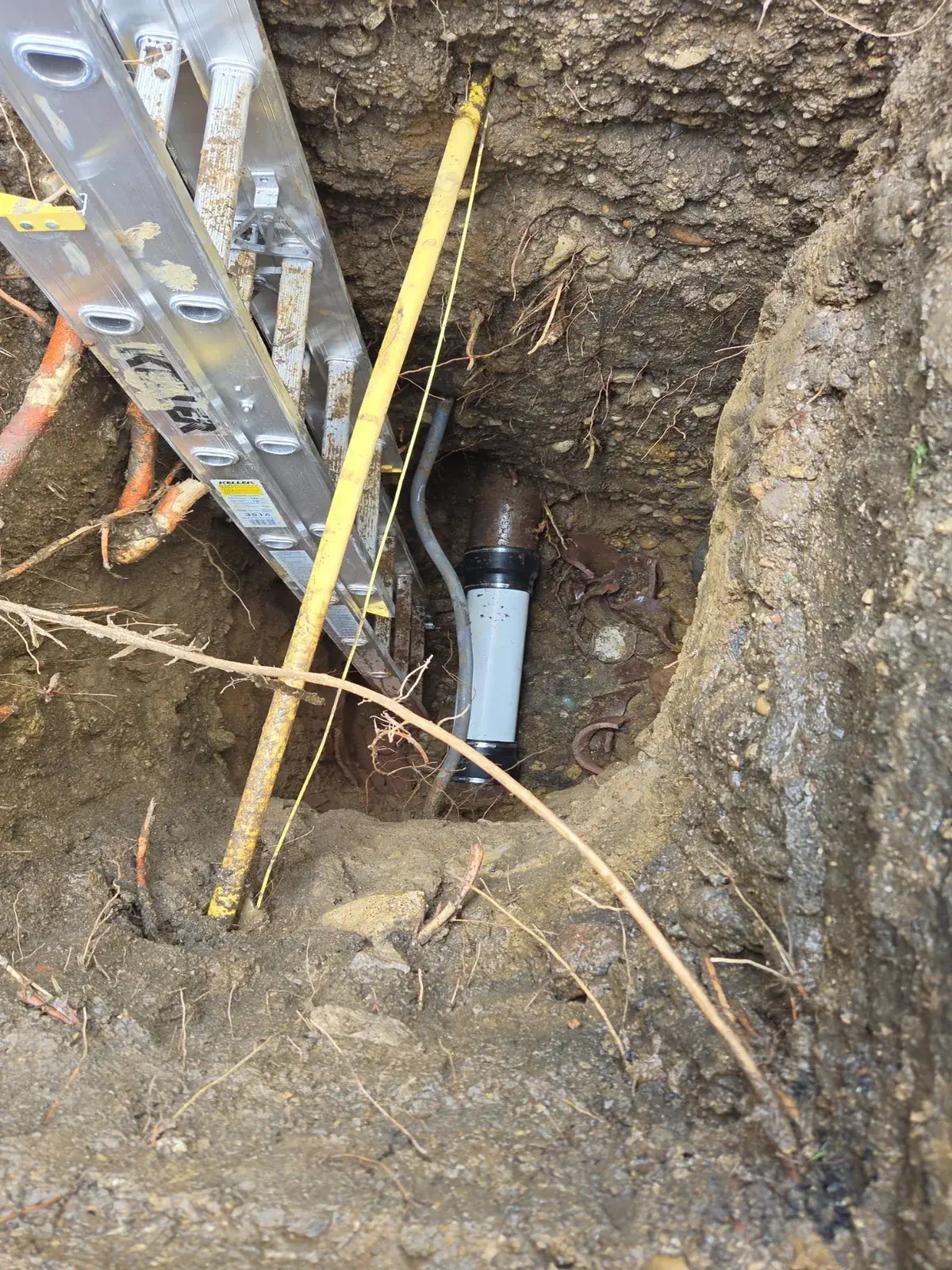 New pipe coupling installed in an open trench