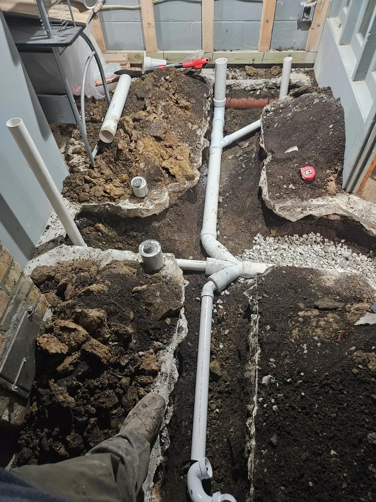 New sewer line and cleanout set in an opened floor